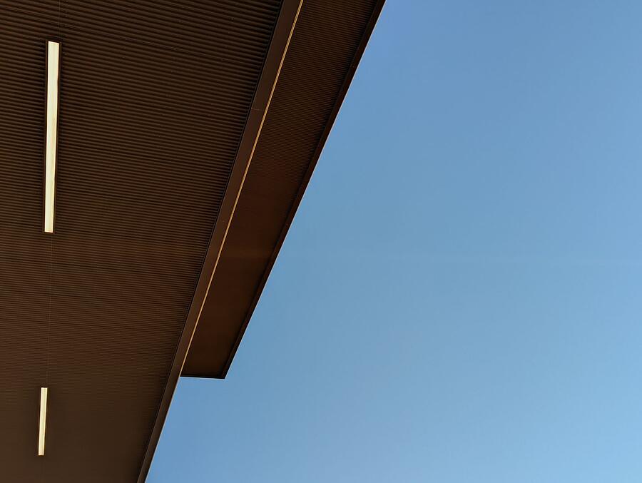 The underside of a soffit and fascia against a blue sky