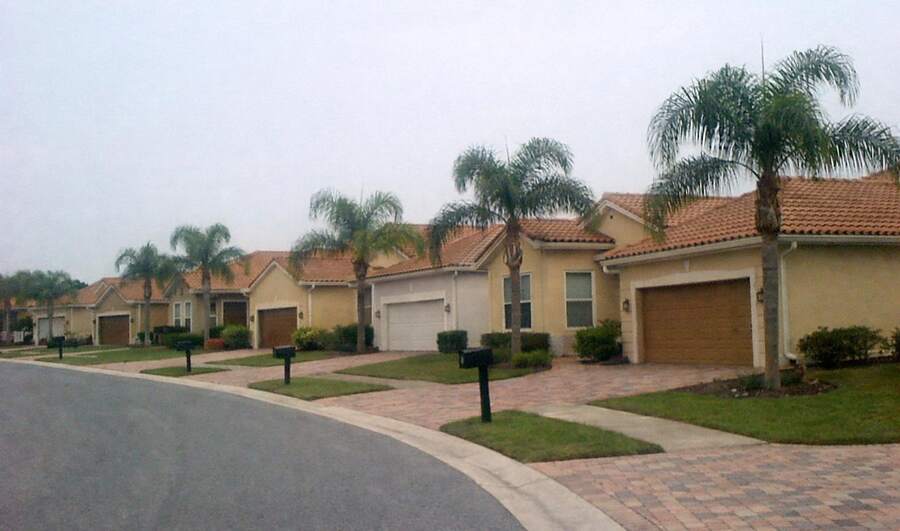 Stucco houses with palms along a suburban street